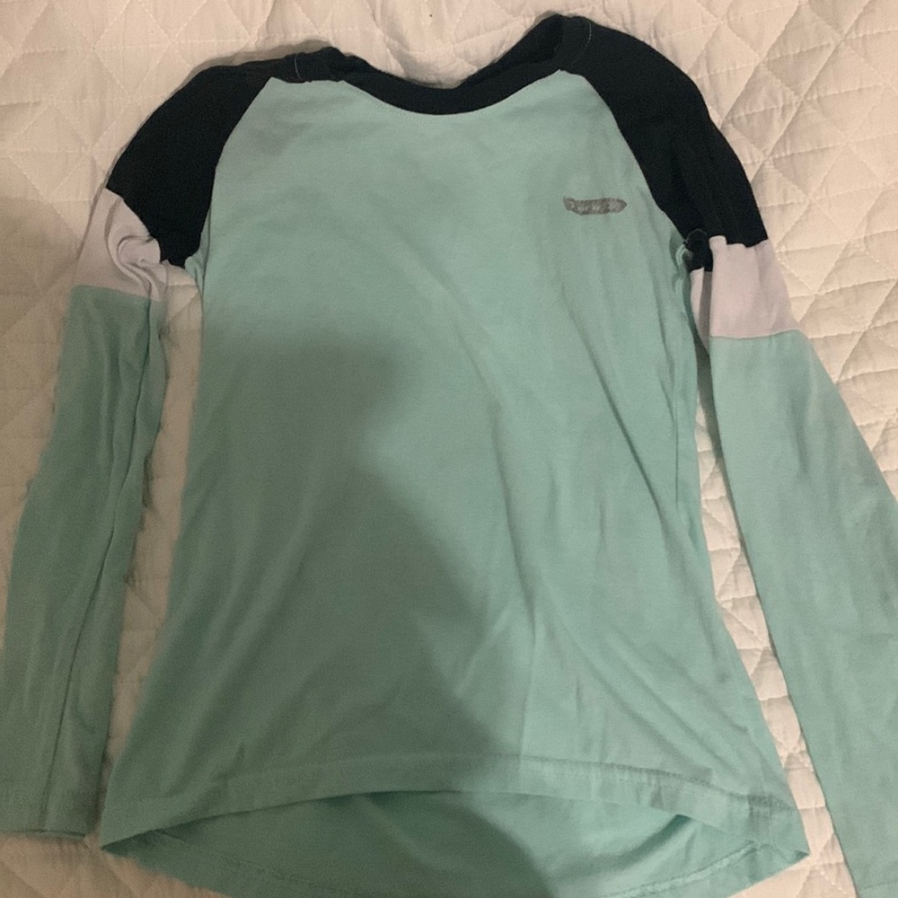 selling a long sleeves with teal black and white on it.